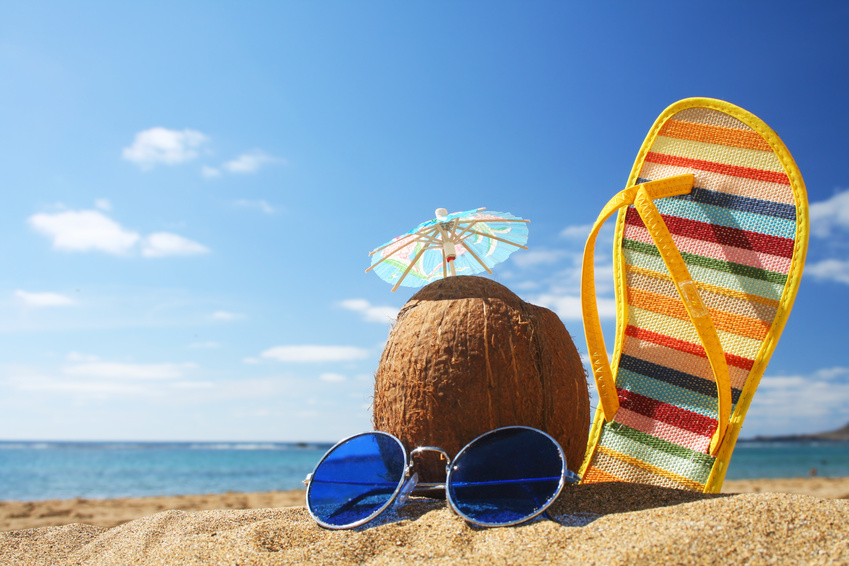 Stilllife on the beach with sunglasses cocktail in coconut and flip flop